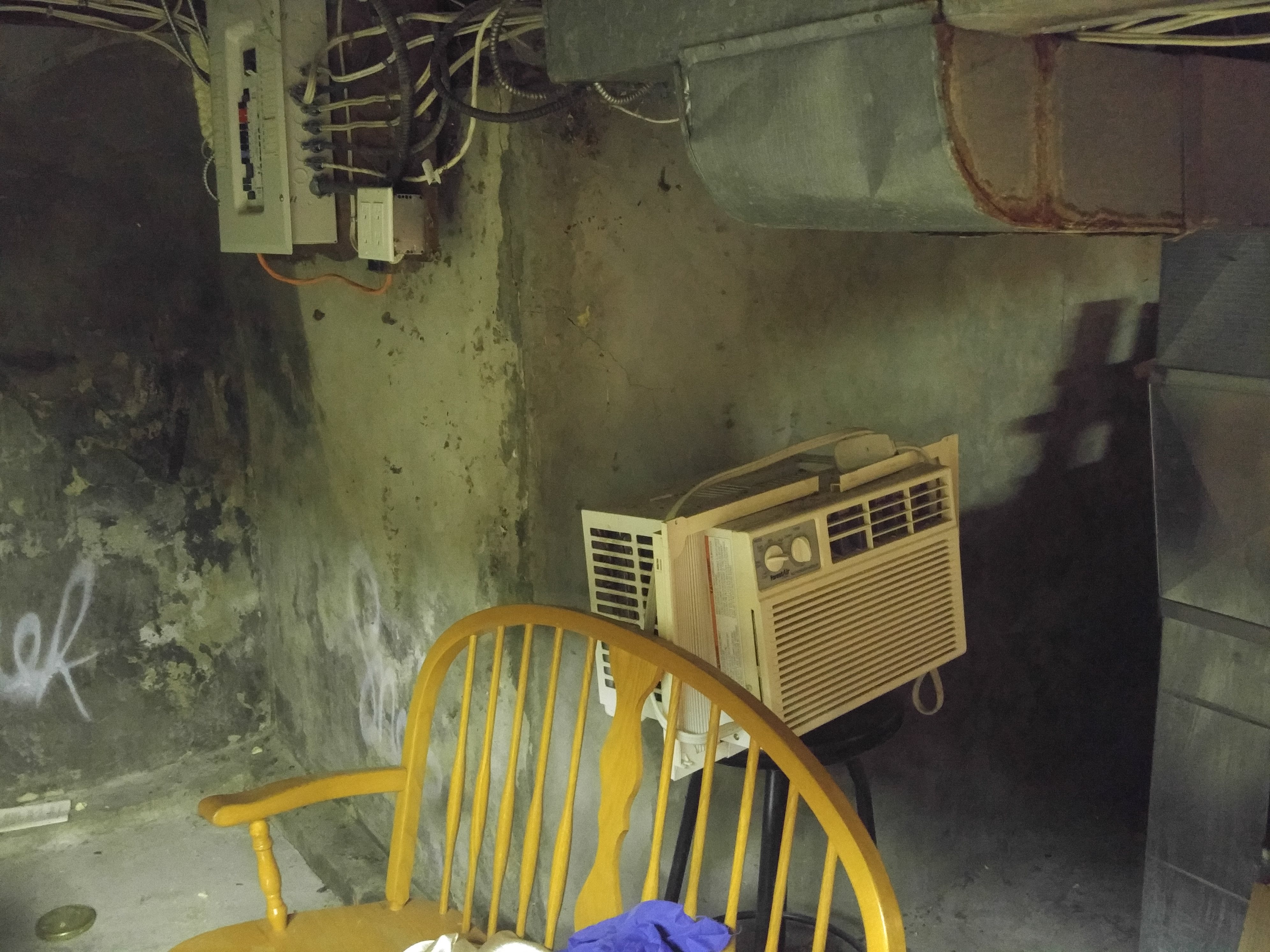 An air conditioner or some other such device sitting against a wall
