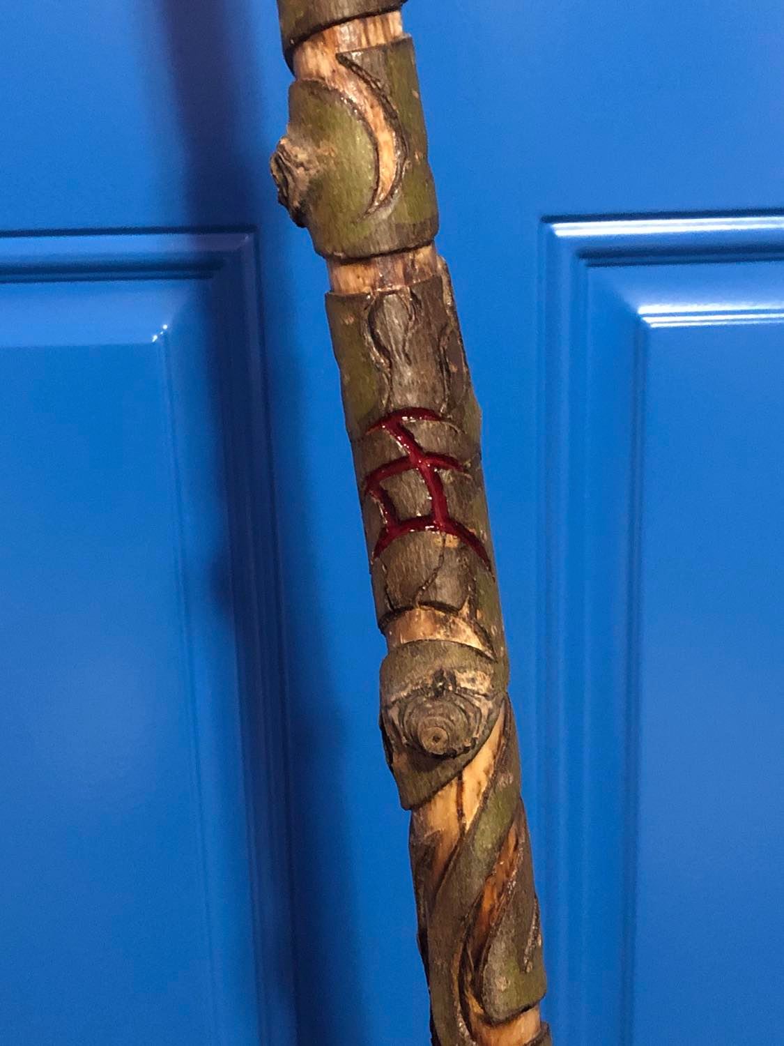 A blood red symbol carved into the base.