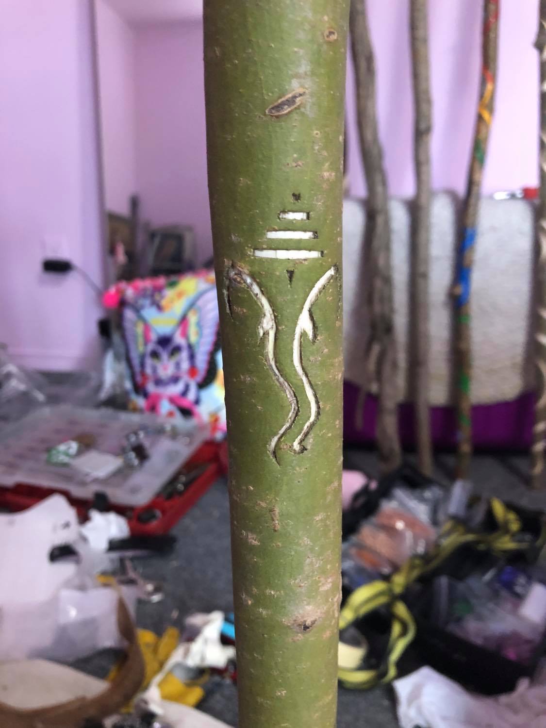A symbol for Ganesha on the staff.