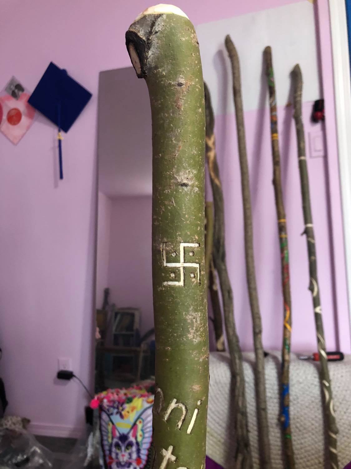 The Hindu Swastika carved into the staff.