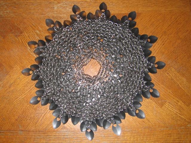 Showing the underside again, densely packed and showing 14 tips of scales around the outside.