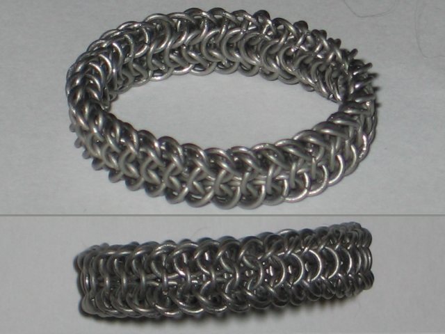 A split photo, showing the chainmaille ring from above at an angle, and directly on the side. A dense weave of small rings, which has a curved inner side, and a more rigid, sharper-edged outside.