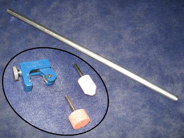 A pic of a steel tube, on a blue surface, and an inset pic of some stone bits, and a tube cutting tool.