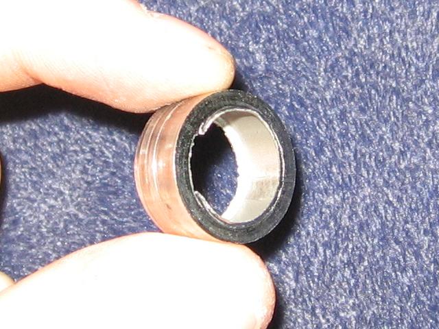 Showing a centimeter-wide section of the tubing cut off, with sharp burrs on the inside edge.