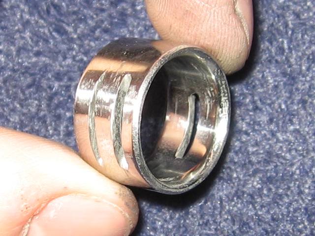 Kabutroid holding the ring, showing how shiny and reflective it is.