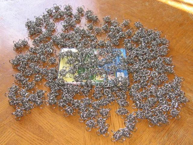 The whole pile of orbs scattered closely on a table, generally covering a DVD of Collision Course, the Steve Irwin Crocodile Hunter movie.