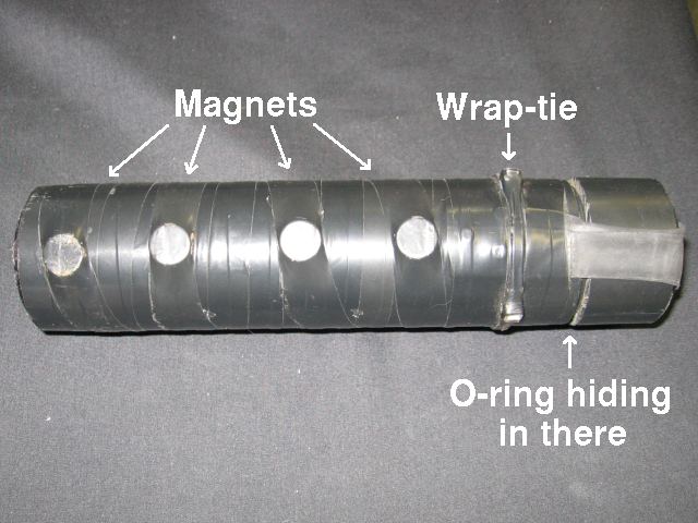 Showing a stretch of four magnets attached along one side of the container.