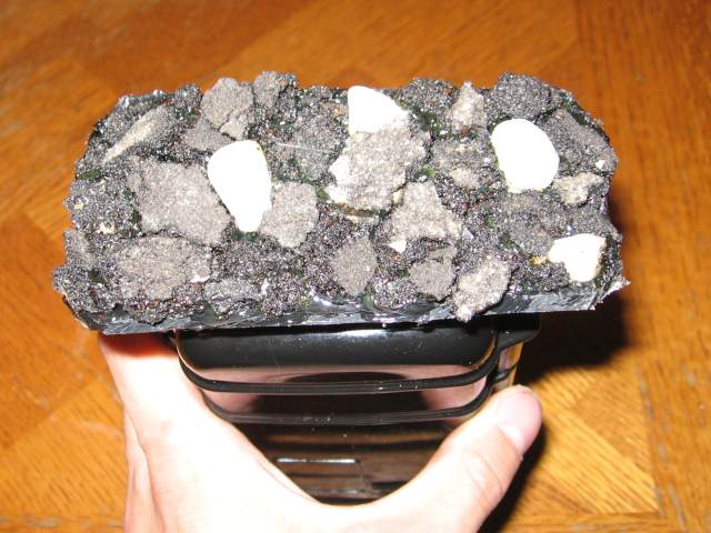 The channel first filled with asphalt and rocks, to hide the plastic beneath the sticks.