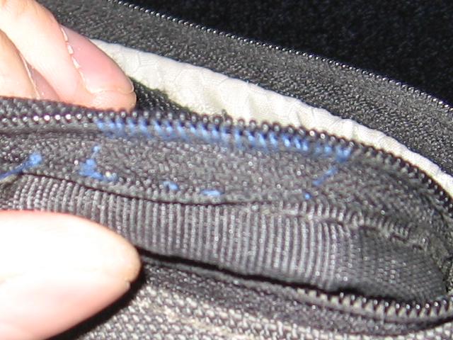 The inside of the zipper, showing all of the thread pulled tight.