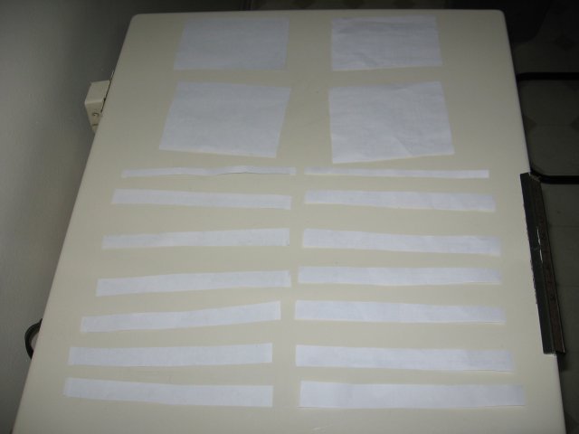 A whole pile of strips of regular and all-weather paper cut out and laid in a row.