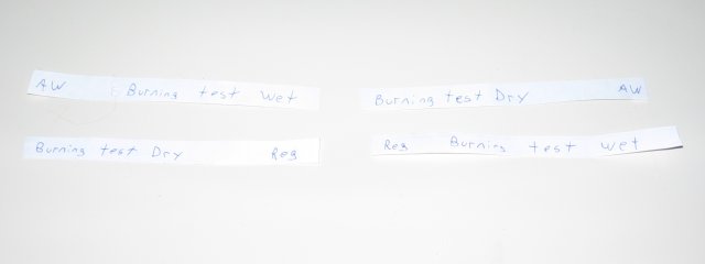 Four strips of paper, with regular and all weather wet and dry paper.