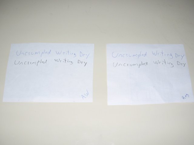 The two paper types with uncrumpled writing dry written on both in pencil and ink.