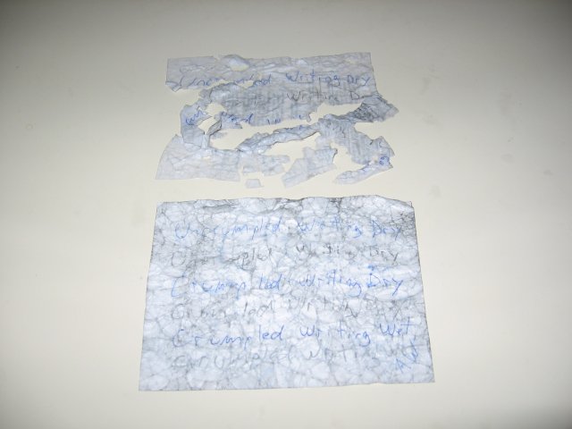 The regular paper being completely shredded and barely piece togetherable, and the all weather paper being able to flatten out better than before now. The text is still visible, though the ink has bled into the creases.