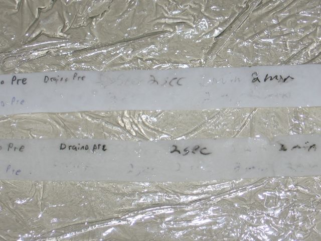 The two pieces of paper, showing the regular paper being very fragile, though both appear about the same colour.