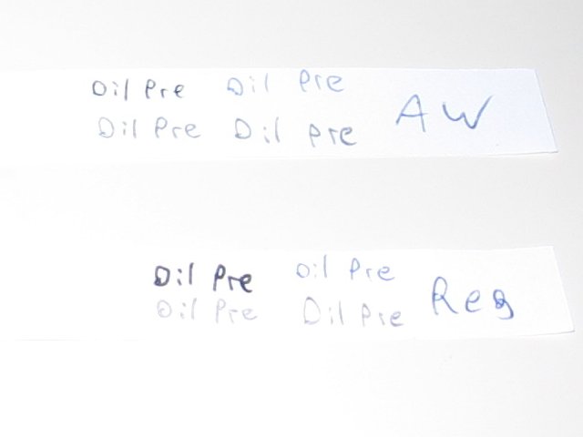The two test strips with oil pre written in the four writing types.