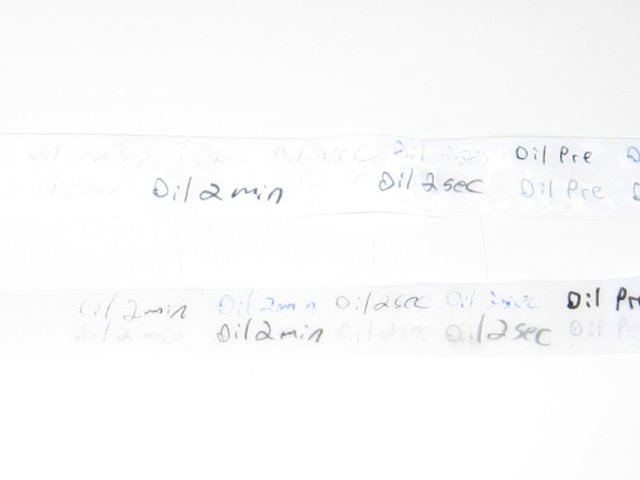 The two papers with almost unreadable text on the all weather paper, but more readable on the regular paper.