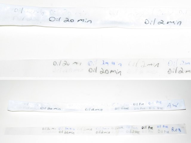 The test strips, showing that the regular paper did better with writing after being submerged in oil, and held up physically as well!