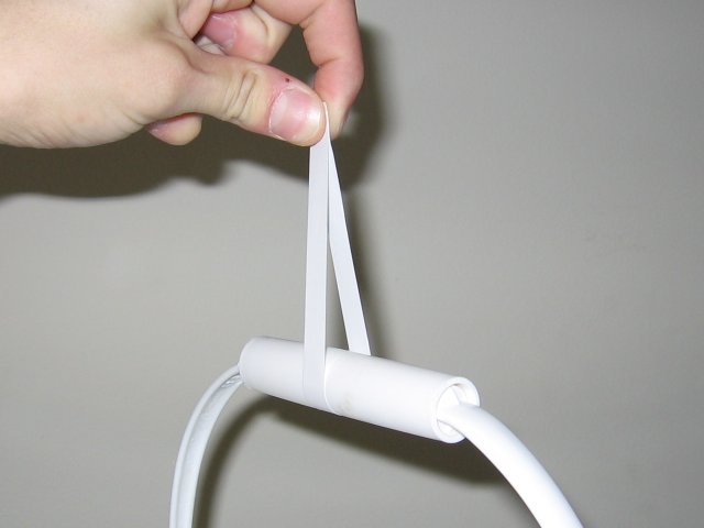 A thin strip of paper wrapped around the handle of the bucket and pulling up.