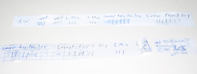The two strips of paper, with the regular paper being broken apart in one spot.