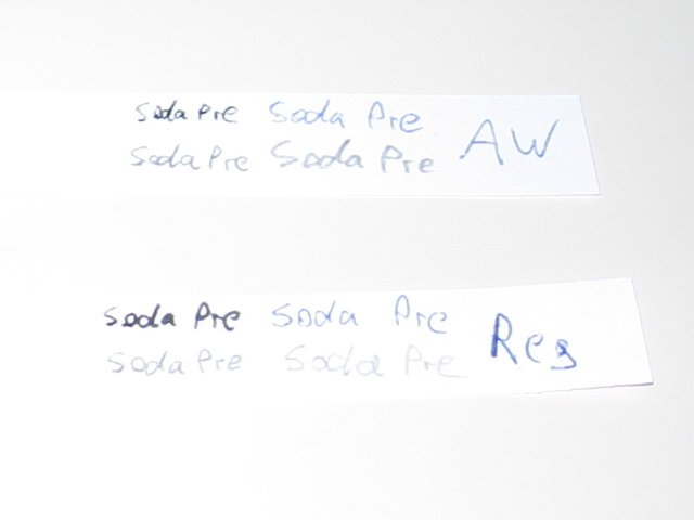 The two strips of paper with soda pre written on it in the four writing types.