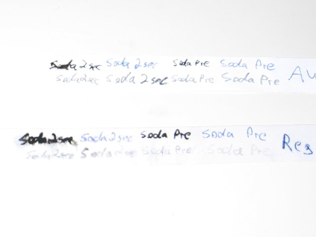 The two pieces of paper, with heavy bleeding of the gel pen on each.
