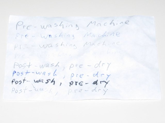The same paper with post-wash, pre-dry written on it, with slightly blurry text.
