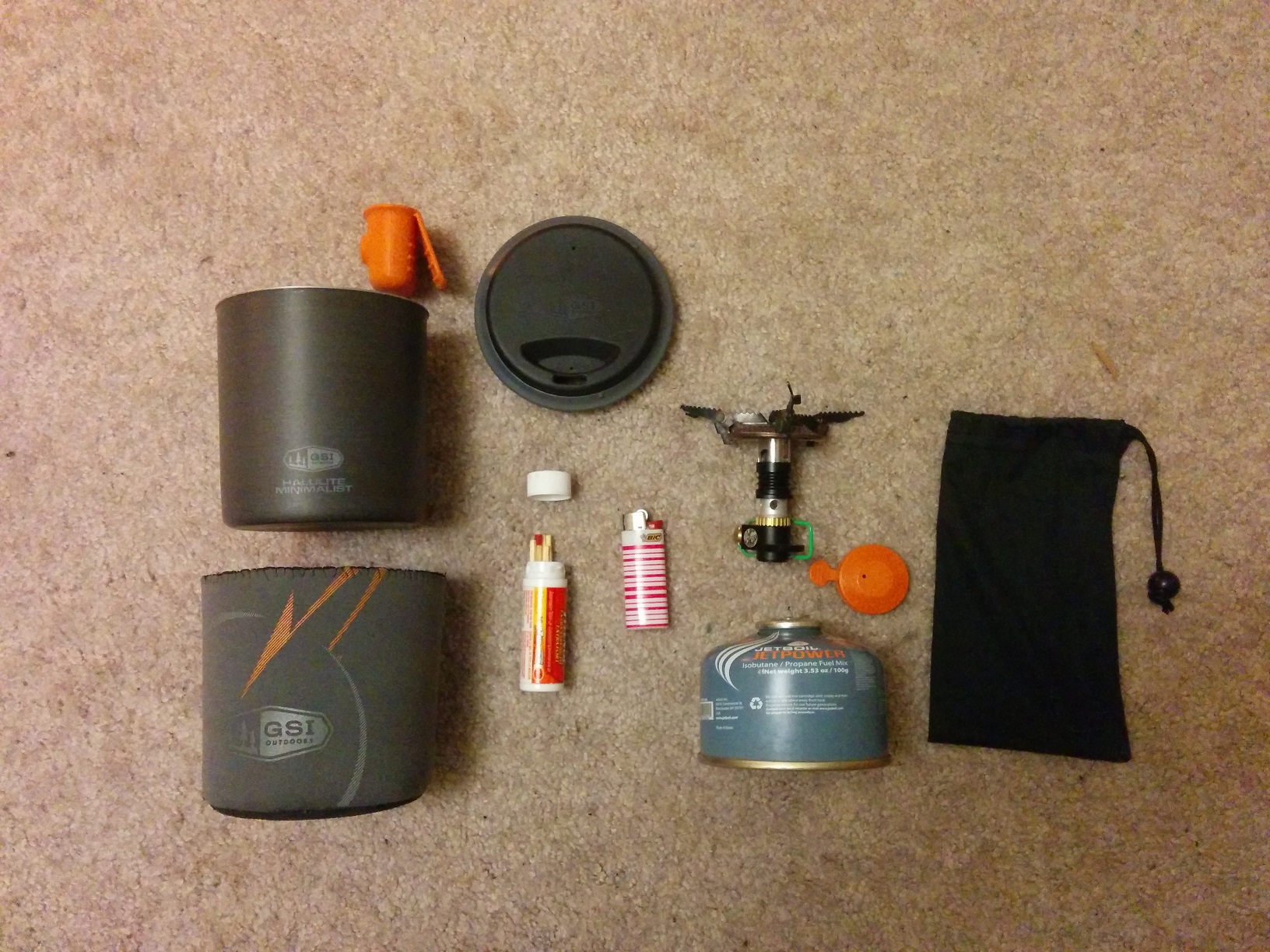 The contents of the cooking stove, and all of the individual items in there, arranged on the carpet.