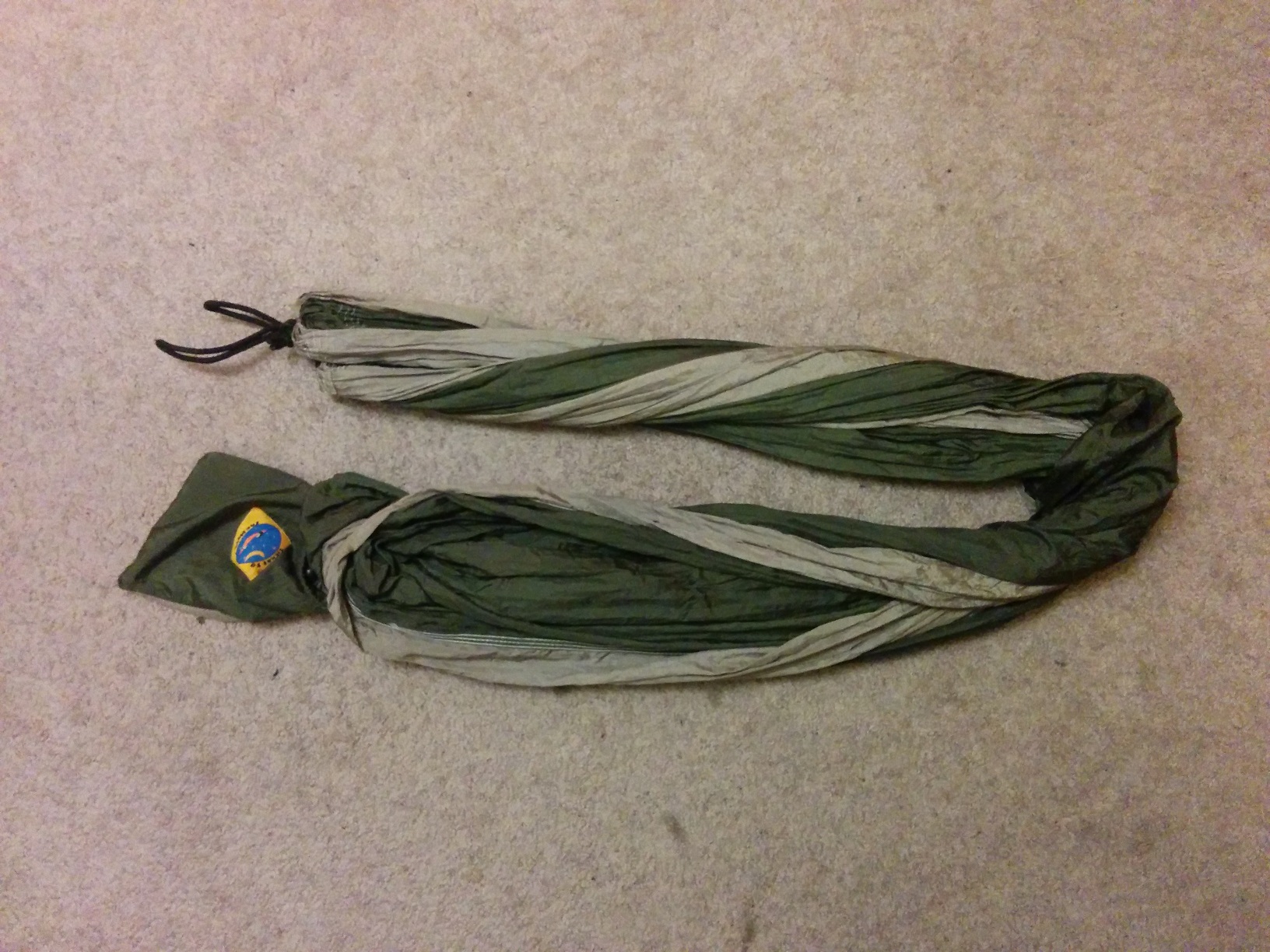 The straps removed, and the hammock folded in half, and then partially in half again.