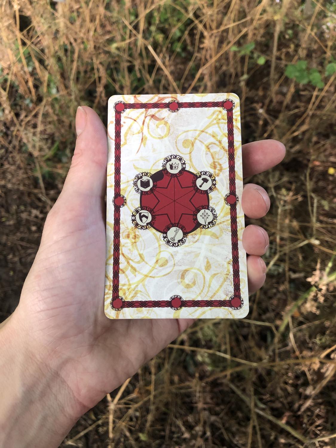 A witch holds the harrow deck in the grasses. Asked for a card, have you.
