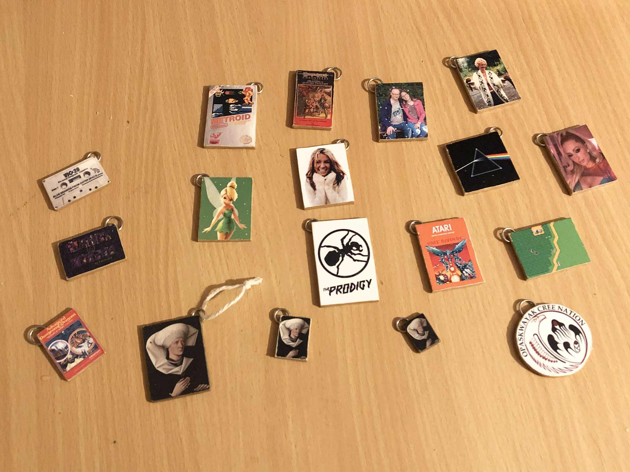 Eighteen Christmas ornaments designed to look like photos of icons like Paris Hilton and Britney Spears, Kabutroid and Abby, their parents, video games, books, bands, and other miscellaneous similar things, each about an inch and a half tall.