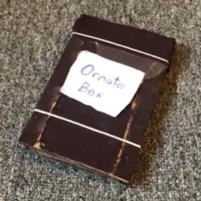 A rough brown box on grey carpet