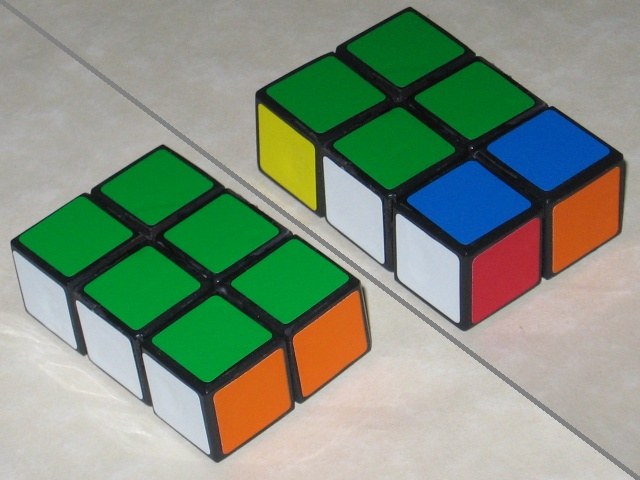 Another split photo, with brand new stickers applied, and a bright and vibrant green, white, and orange is facing the camera, and in the other pic it's scrambled, with much green showing.