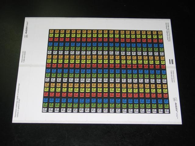 A sticker sheet with rows of coloured squares printed, looking like the floor tiles in the game Metroid, but in each of the cube colours.