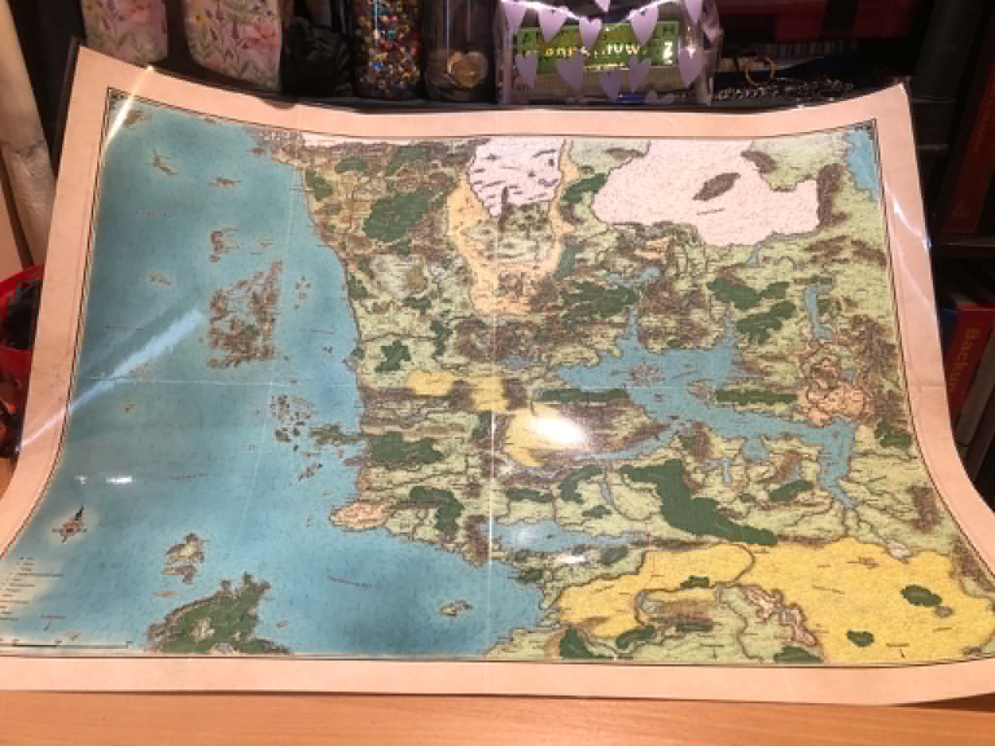 A laminated map of Faerun, spread out on Kabutroid's workbench.